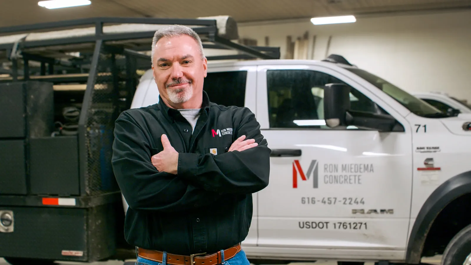 A Michigan business owner Sympl serves, in front of his company truck